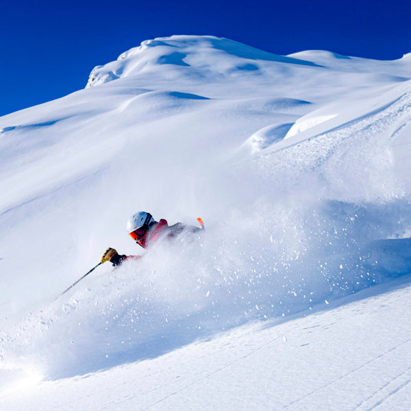 A skier skis deep snow at Tordrillo Mountain Lodge