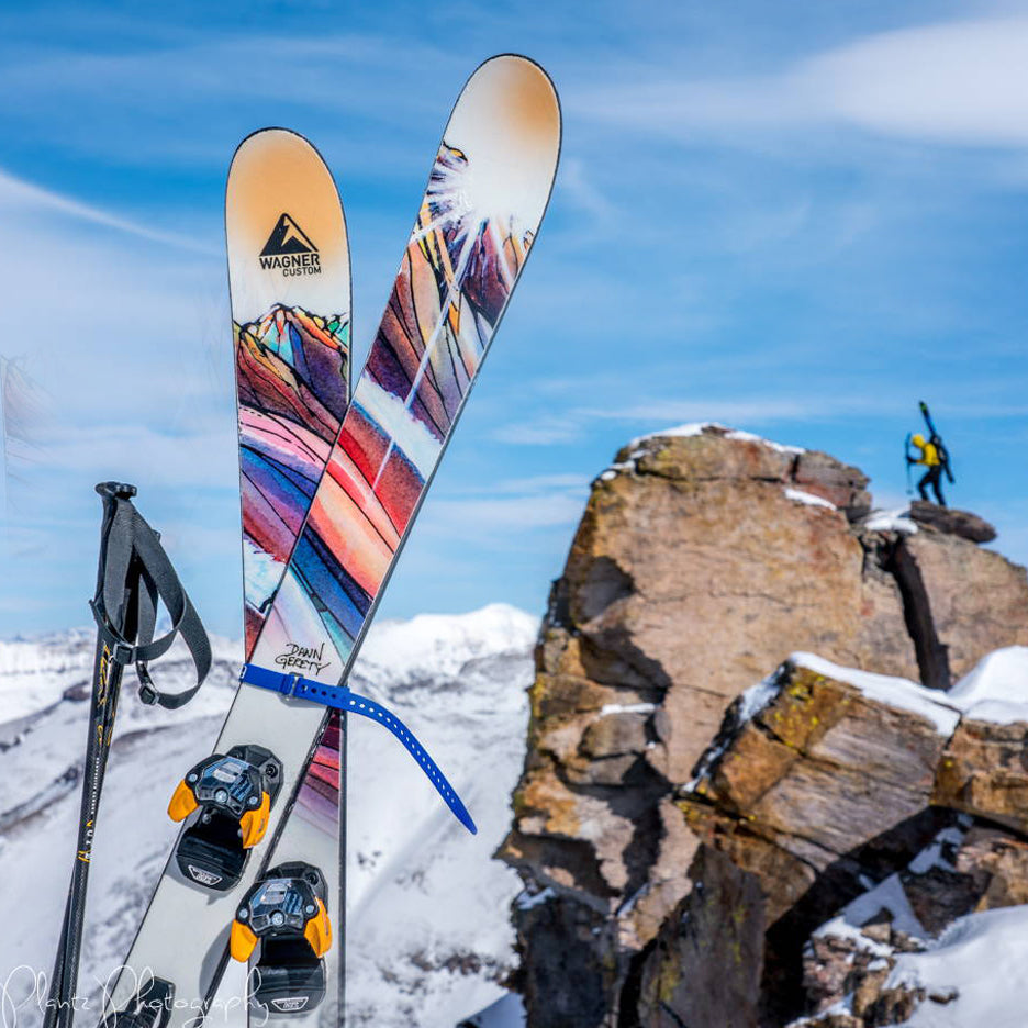 A pair of skis frames a skier on Palmyra Peak